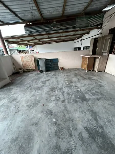 Exterior features: concrete flooring, overhead metal roof, exposed beams, partial wall enclosure, wooden storage cabinet, plastic garbage bins, open space, unfurnished area.