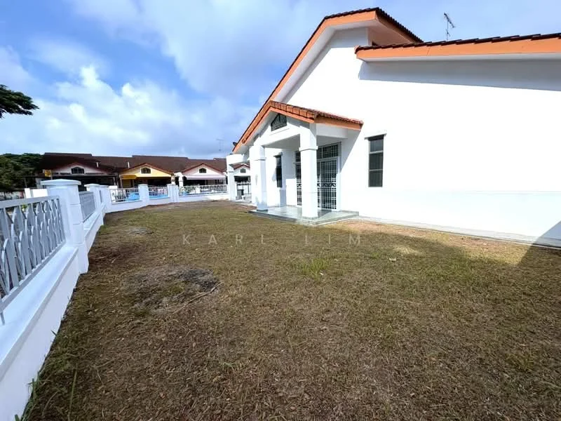 Exterior type: detached bungalow; features: white painted facade, flat roof, manicured lawn, surrounded by low fencing, concrete walkway, single-storey, landscaped garden area; style: modern.