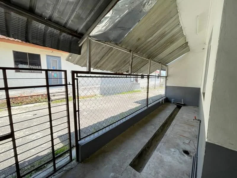 Exterior features: metal roof, chain-link fence, concrete flooring, grey painted walls, covered walkway, open space, adjacent to road; style: modern.