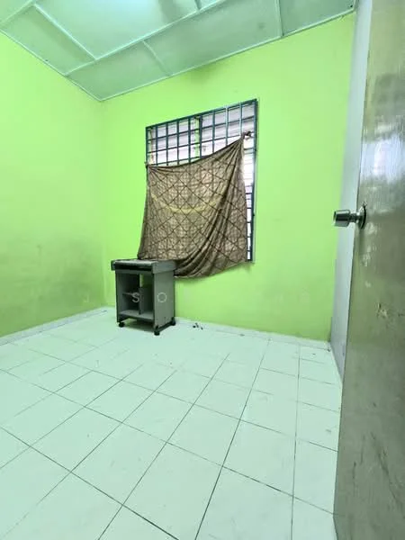 Room features: green painted walls, tile flooring, window with curtain, single desk, plain ceiling, door, natural light from window.