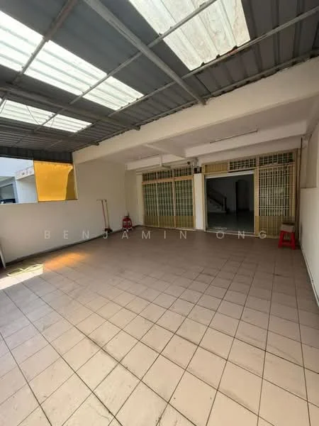 Room features: tiled flooring, white painted walls, exposed ceiling with metal beams, large windows, natural light from skylights, open layout, no visible furniture, two red plastic stools.