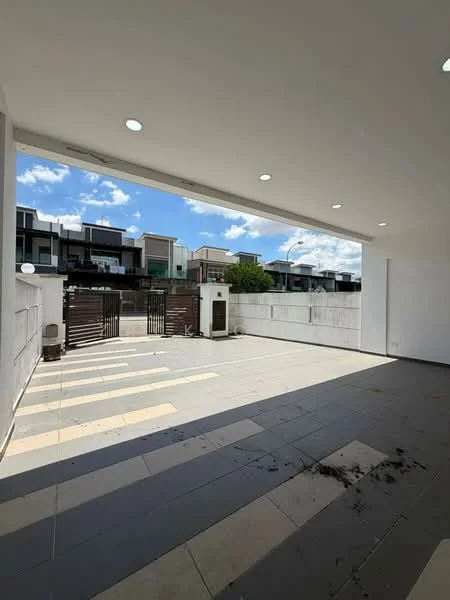 Exterior type: linked terrace house; features: paved driveway, gated entrance, white painted walls, flat roof, manicured landscaping, surrounded by residential buildings, outdoor lighting, open-air parking area; style: modern.