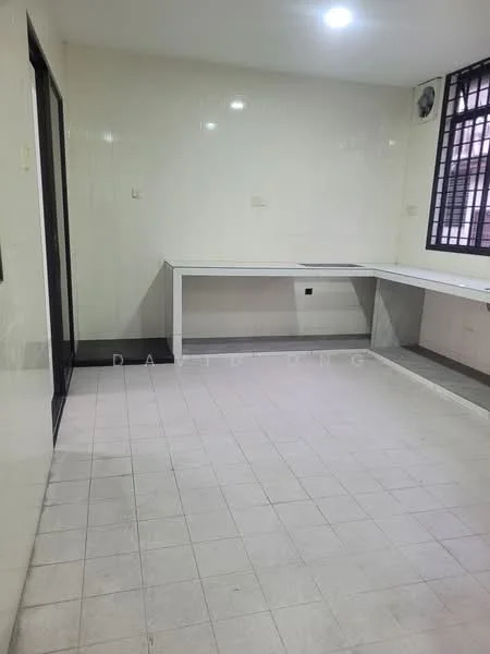 Room features: white painted walls, tile flooring, ceiling lights, large window with security bars, built-in countertop, open layout, neutral color scheme, no visible furniture; style: modern.