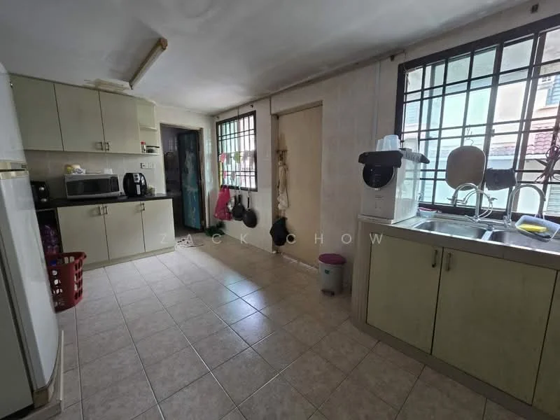 Kitchen features: light green cabinetry, stainless-steel sink, chrome pull-down faucet, white tiled backsplash, ceramic tile flooring, built-in microwave, freestanding refrigerator, countertop space, window with metal grille, hanging pots and pans, basket for laundry, light fixture, open shelving.