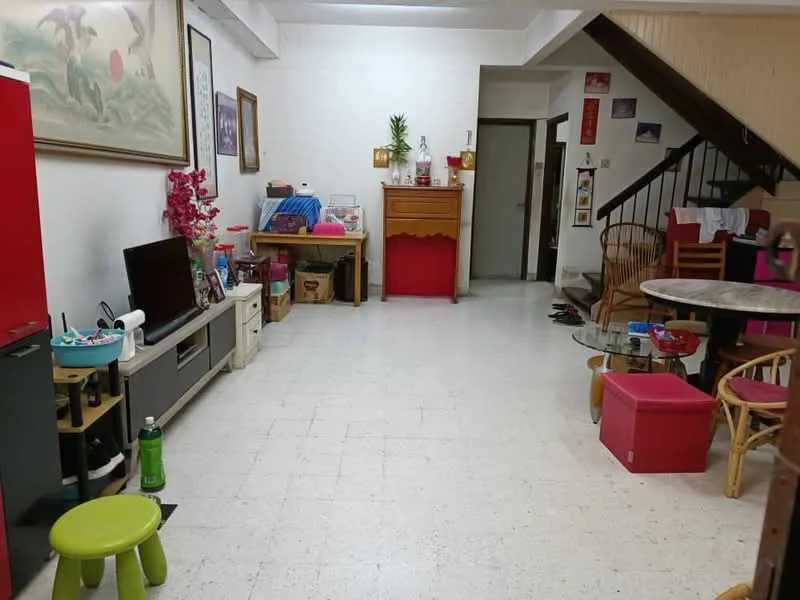 Living features: white painted walls, tile flooring, ceiling with exposed beams, wall-mounted TV, wooden sideboard, round dining table, 4 wooden chairs, coffee table, green stool, red storage box, decorative plant, framed artwork, staircase leading to upper floor, open layout; style: traditional.