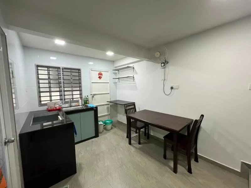 Kitchen features: black countertop, single-bowl stainless-steel sink, chrome pull-down faucet, white cabinetry, grey tiled flooring, wall-mounted shelving, window with metal grilles, dining table with four chairs, refrigerator, light fixture, wall-mounted fan; style: modern.