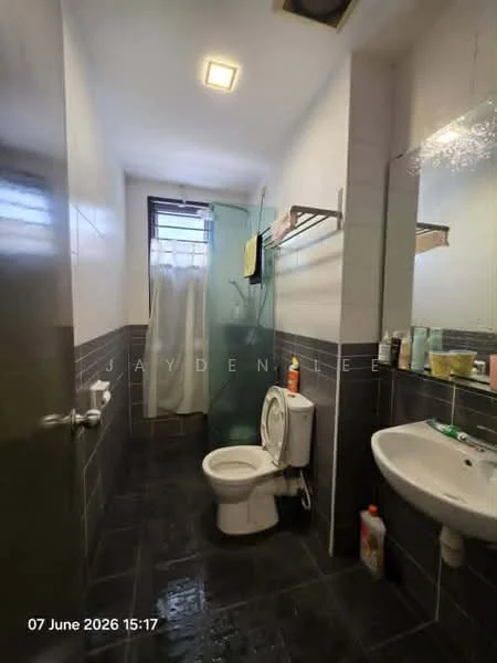 Bathroom features: white tiled walls, dark grey tiled flooring, one-piece toilet, single-sink vanity, mirror above sink, glass shower enclosure, shower curtain, towel rack, soap dispenser, toilet paper holder; style: modern.