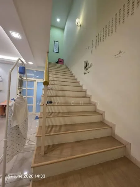 Room features: wooden staircase, light-colored wooden steps, white handrail, wall-mounted lighting, painted walls in light green, decorative wall art, open space at the bottom of the stairs, flooring with light tiles; style: modern.