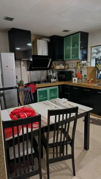 Kitchen features: black cabinetry with green glass panels, wood countertop, stainless-steel range hood, built-in microwave, freestanding refrigerator, black countertop appliances, ceramic tile flooring, dining table with four black chairs, kitchen utensils on countertop, wall-mounted shelves, sink with faucet, open shelving, decorative plants; style: modern.