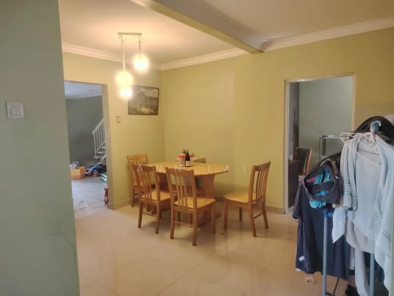 Dining features: wooden dining table, 4 wooden dining chairs, green painted walls, white ceiling with crown moulding, hanging pendant lights, marble tile flooring, open layout to living area, doorway to adjacent room; style: modern. Room features: clothes rack, visible clutter in background.