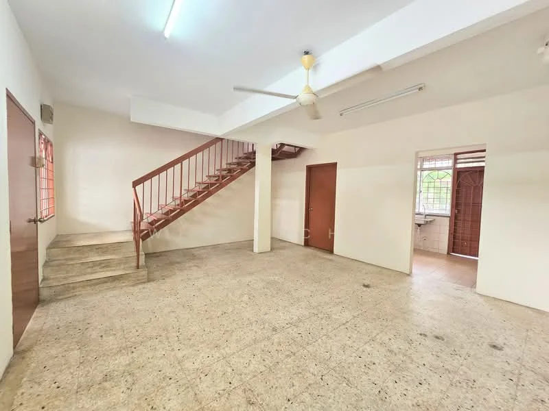 Room features: staircase with wooden railing, plain white walls, cement flooring, ceiling fan, windows with metal grilles, door with wooden finish, natural light from windows, open layout; style: minimalist.