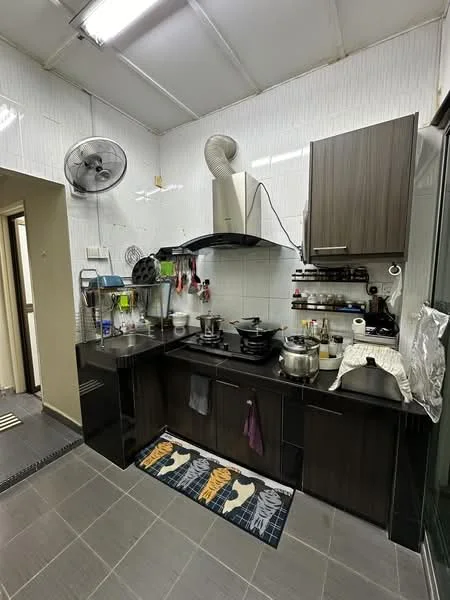 Kitchen features: black laminate cabinetry, white tiled backsplash, stainless-steel sink, chrome pull-down faucet, built-in stove, exhaust hood, black countertop, grey tile flooring, 2 wall-mounted ceiling fans, kitchen mat with graphic design, various cooking utensils, multiple pots and pans; style: modern.
