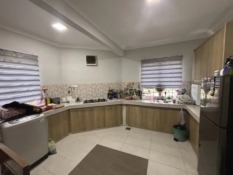 Kitchen features: L-shaped countertop, stainless-steel sink, chrome pull-down faucet, built-in gas hob, exhaust hood, wood cabinetry, white tiled backsplash, grey ceramic tile flooring, refrigerator, window with roller blinds, overhead cabinets, kitchen utensils and appliances visible; style: modern.