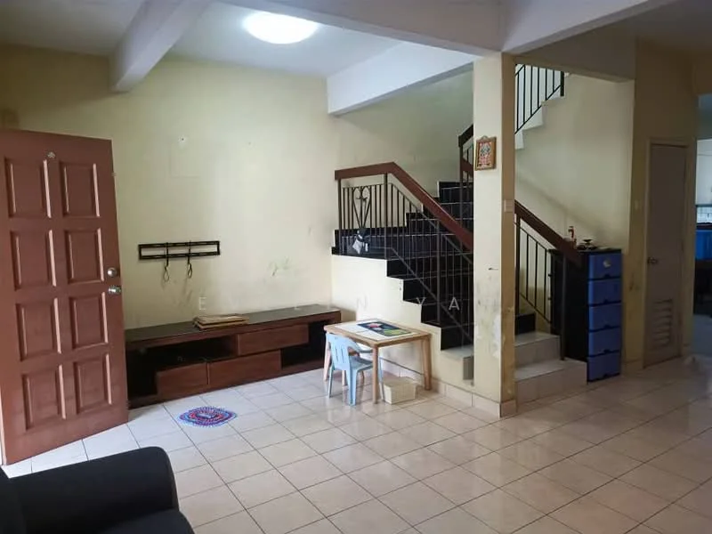 Living features: cream painted walls, tile flooring, sofa, wooden TV console, wall-mounted TV, small table, plastic chair, staircase with black railing, decorative wall art, ceiling light, open space layout.