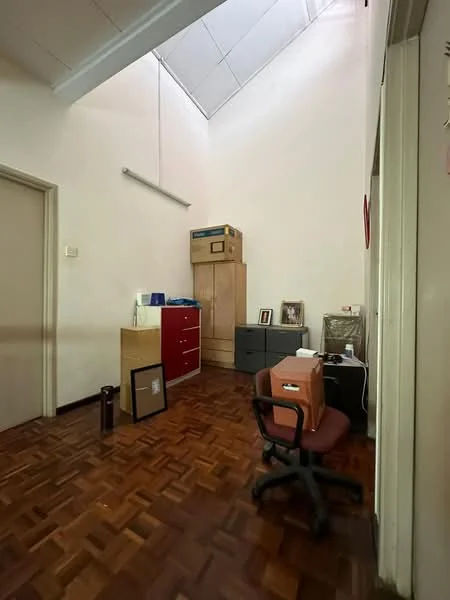 Room features: wooden flooring, white painted walls, high ceiling, built-in wooden cabinets, red cabinet, grey cabinet, framed artwork, office chair, desk, window with natural light; style: modern.