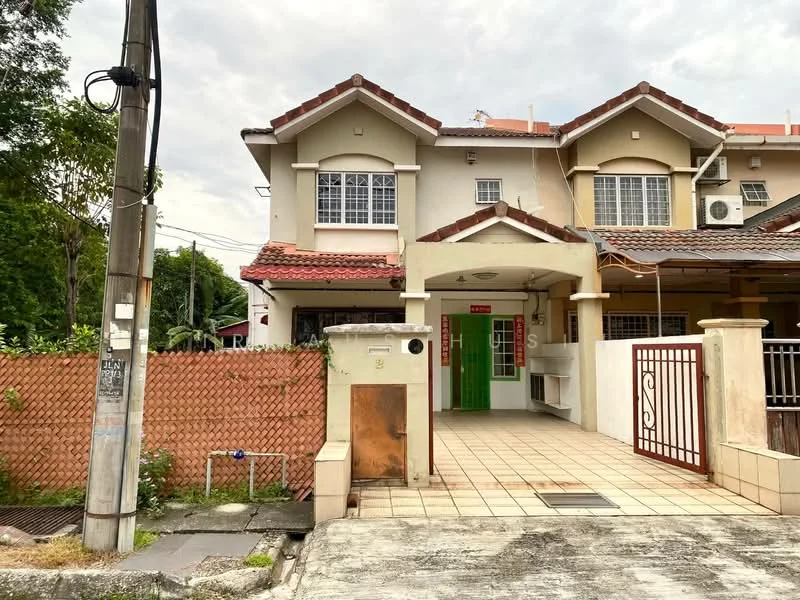 Exterior type: linked terrace house; features: cream painted facade, red tiled roof, front porch with tiled flooring, green main entrance door, white window frames, exposed brick wall, fenced yard with wooden gate, landscaped garden area, utility pole visible, paved driveway, two-storey structure; style: modern.