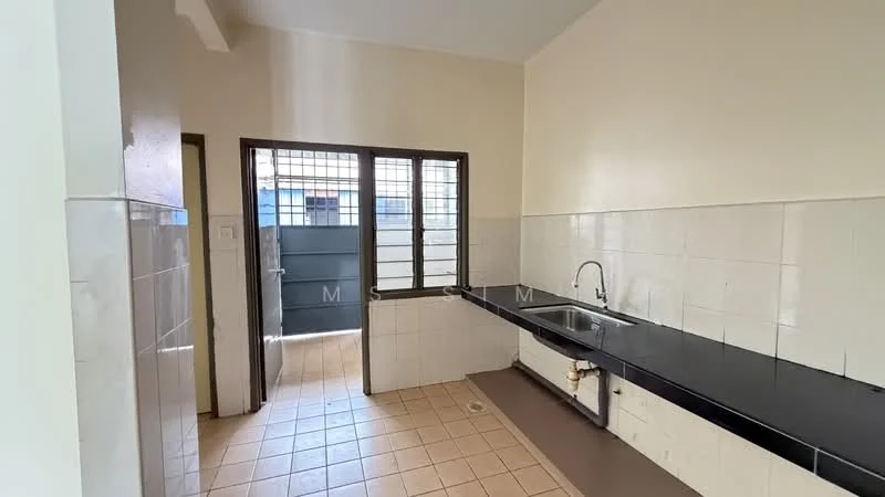 Kitchen features: black granite countertop, single-bowl stainless-steel sink, chrome pull-down faucet, white tiled walls, cream tiled flooring, window with security bars, door leading outside, built-in cabinetry, wall-mounted light fixture.