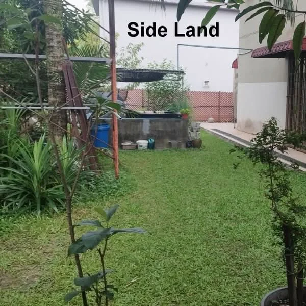 Exterior features: manicured lawn, side garden, fenced area, paved walkway, tropical landscaping, planters with plants.