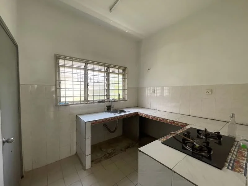 Kitchen features: white tiled walls, white tiled flooring, single-bowl stainless-steel sink, gas stove with two burners, window with metal grille, countertop with tiled edge, open layout, no upper cabinetry.
