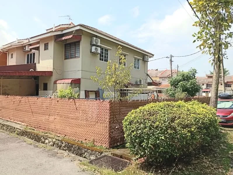 Exterior type: semi-detached house; features: two-storey structure, cream painted facade, pitched tile roof, visible air conditioning units, fenced yard with wooden fencing, manicured shrubbery, paved walkway, surrounded by residential area; style: traditional.