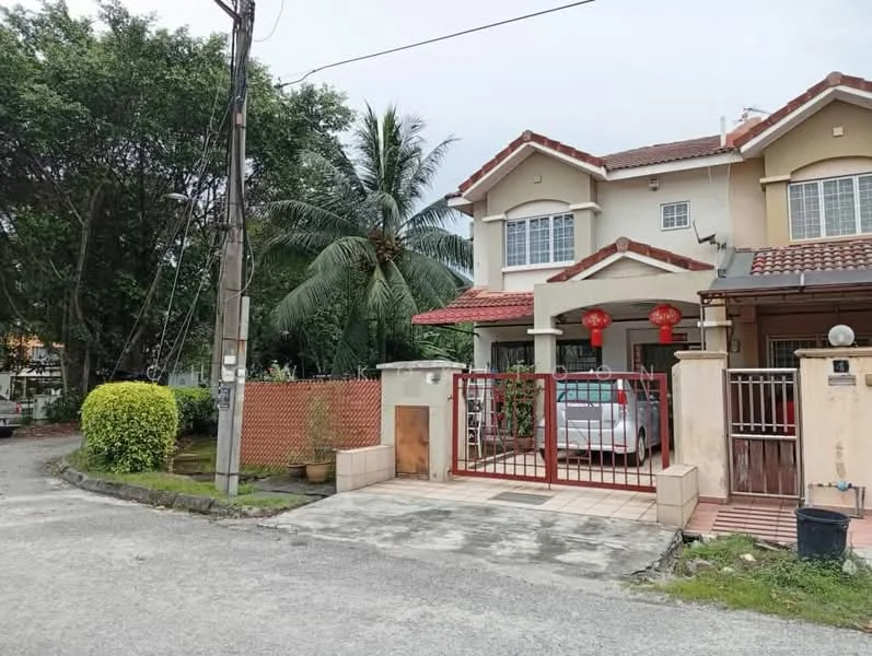 Exterior type: semi-detached house; features: two-storey house, red gate, paved driveway, front garden with manicured bushes, tropical landscaping with palm trees, decorative fence, tile roof, visible car in driveway, surrounded by greenery, street view with power lines; style: modern.