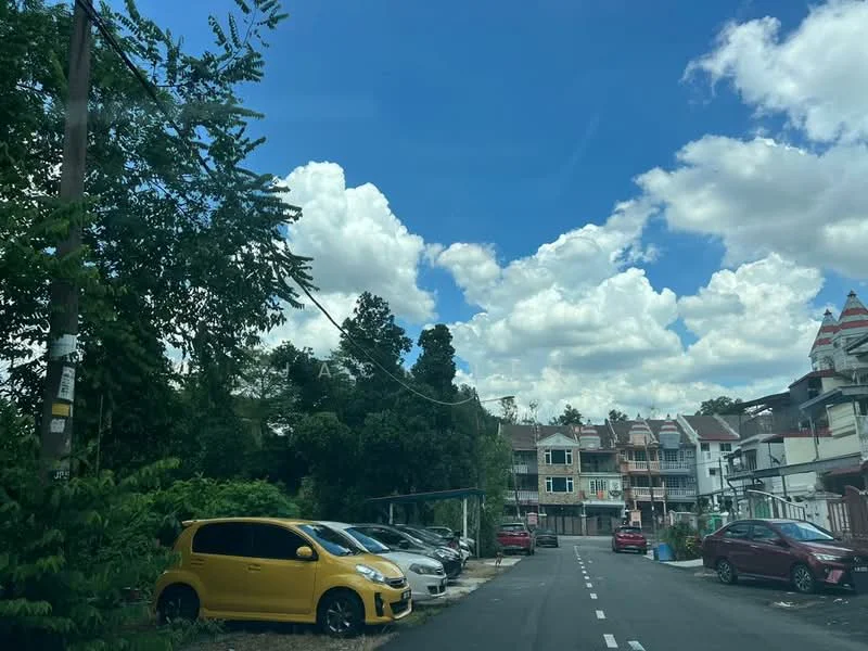 Exterior type: linked terrace house; features: two-storey linked terrace houses, white painted facade, front porches, paved driveway, manicured landscaping, surrounded by greenery, clear blue sky, clouds, open parking spaces; style: modern.