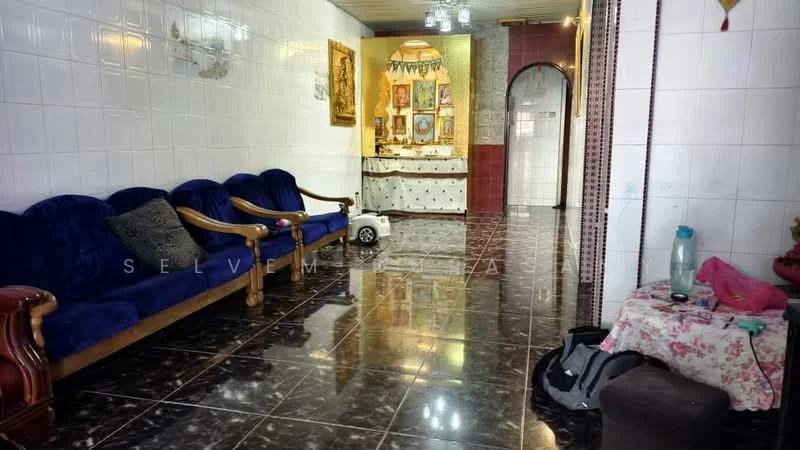Living features: blue fabric sofa with wooden arms, black and white marble flooring, white tiled walls, decorative wall art, chandelier with multiple bulbs, arched doorway, small white table, decorative items on the wall, water bottle on the floor, pink cloth on the table; style: traditional.