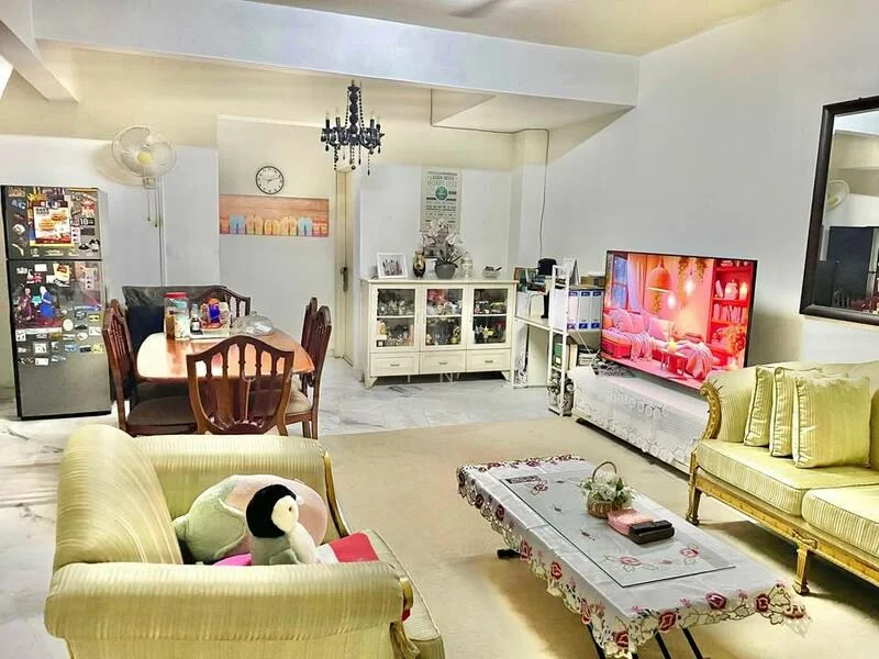 Living features: marble flooring, white painted walls, 5-blade ceiling fan, chandelier, wall-mounted TV, TV console, sofa in light green fabric, coffee table with floral design, decorative wall clock, dining table with wooden chairs, refrigerator, display cabinet, area rug; style: modern.
