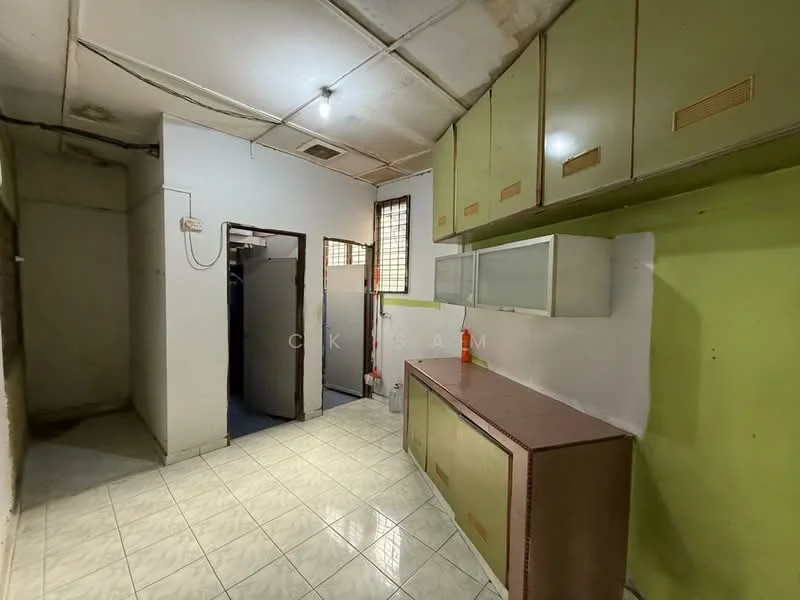 Kitchen features: green cabinetry, white tiled flooring, countertop with storage below, wall-mounted cabinets, single-bowl stainless-steel sink, window for natural light, exposed ceiling with beams, light fixture on ceiling. Room features: plain walls, unknown flooring.