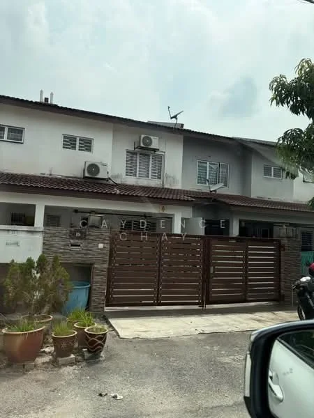 Exterior type: linked terrace house; features: two-storey building, brown wooden gate, stone cladding on lower facade, white painted facade, multiple wall-mounted split AC units, windows with grilles, roof with overhang, paved driveway, garden area with potted plants, satellite dish on roof; style: modern.