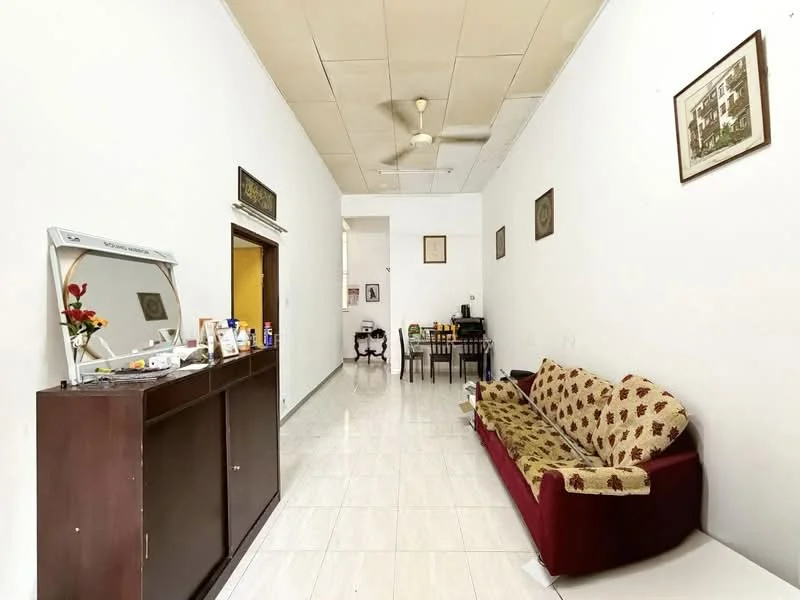 Living features: white painted walls, glossy tile flooring, ceiling fan, 3-seater fabric sofa with floral pattern, wooden console table, dining table with chairs, framed artwork on walls, decorative plants; style: minimalist.