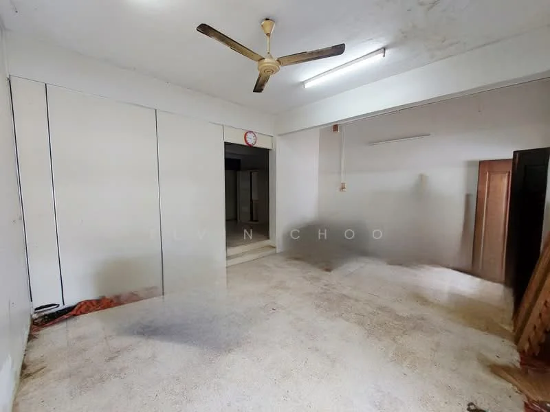 Room features: ceiling fan, white painted walls, concrete flooring, built-in cabinets, wall clock, doorway leading to another room, natural light from adjacent room.