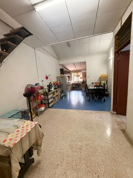 Room features: staircase leading to upper level, polished concrete flooring, white painted walls, kitchen area with cabinets, open layout, dining table with chairs, kitchen appliances visible, window providing natural light, ceiling with tiles, fan mounted on wall; style: modern.