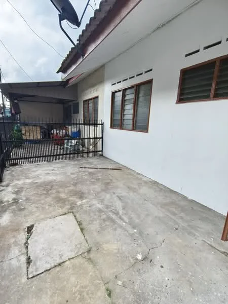 Exterior features: concrete flooring, white painted facade, wooden window frames, metal gate, fenced perimeter, outdoor space, roof overhang, visible utility connections; style: minimalist.