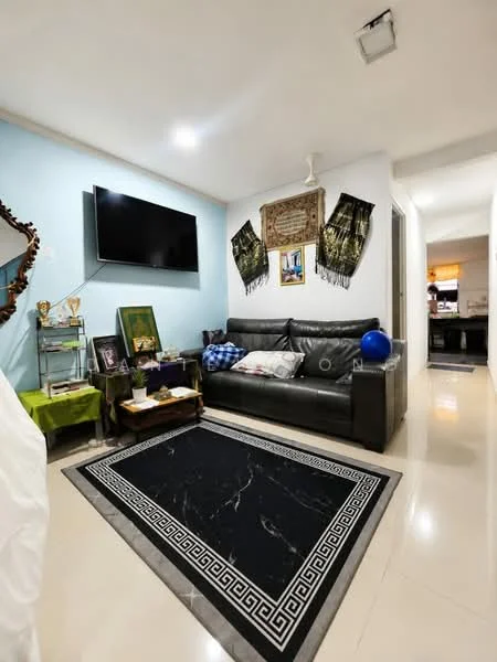 Living features: black leather sofa, flat-screen TV mounted on wall, decorative wall art, area rug with geometric pattern, ceiling fan, light-colored walls, glossy tile flooring, side table with decorative items, green accent table, blue decorative ball; style: modern.