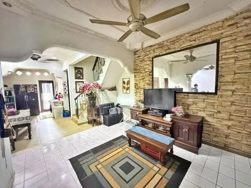 Living features: 5-blade ceiling fan with light, wall-mounted TV, wooden coffee table, area rug with geometric pattern, stone accent wall, framed mirror, decorative plants, upholstered sofa, tile flooring, crown moulding on ceiling; style: modern. Room features: open layout to adjacent room, staircase visible, decorative wall with floral arrangement.