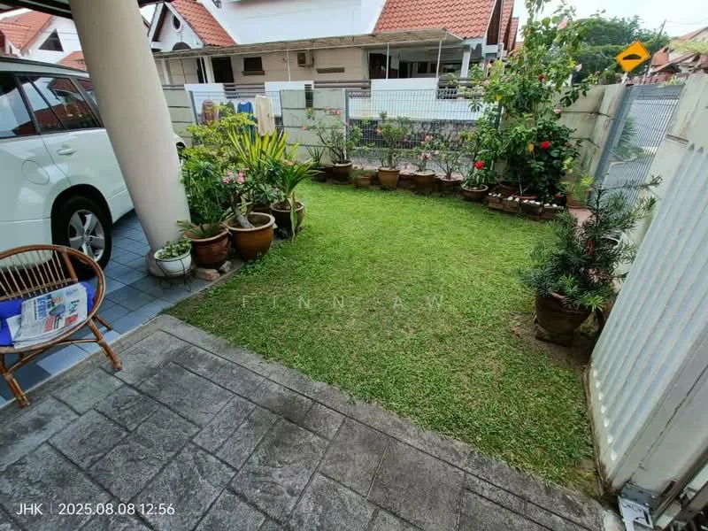 Exterior type: linked terrace house; features: manicured lawn, flower beds with potted plants, stone-paved walkway, fenced garden area, car parked in driveway, covered porch area, brick wall fencing, tile flooring at entrance; style: modern.