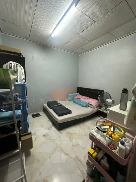 Bedroom features: queen-size bed with upholstered headboard, light blue and pink bedding, marble flooring, grey painted walls, ceiling light fixture, built-in wardrobe, open shelving unit, rolling cart with storage, standing fan.