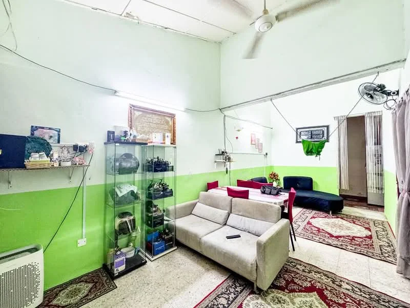 Living features: green painted walls, white painted walls, sofa in light grey fabric, dark blue fabric sofa, coffee table, area rug with geometric pattern, wall-mounted shelves, display cabinet, ceiling fan, wall-mounted air conditioning unit, curtains, decorative wall art.