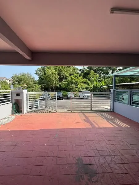 Exterior type: car porch; features: paved flooring, metal gate, surrounded by greenery, open parking area, covered awning, fenced perimeter; style: modern.