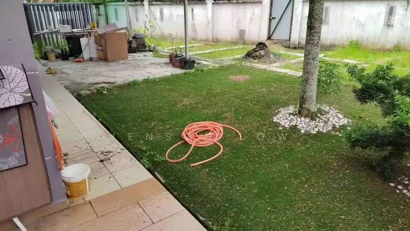 Exterior features: manicured lawn, stone-paved walkway, garden hose coiled on grass, fenced perimeter, gravel path, outdoor space with trees.