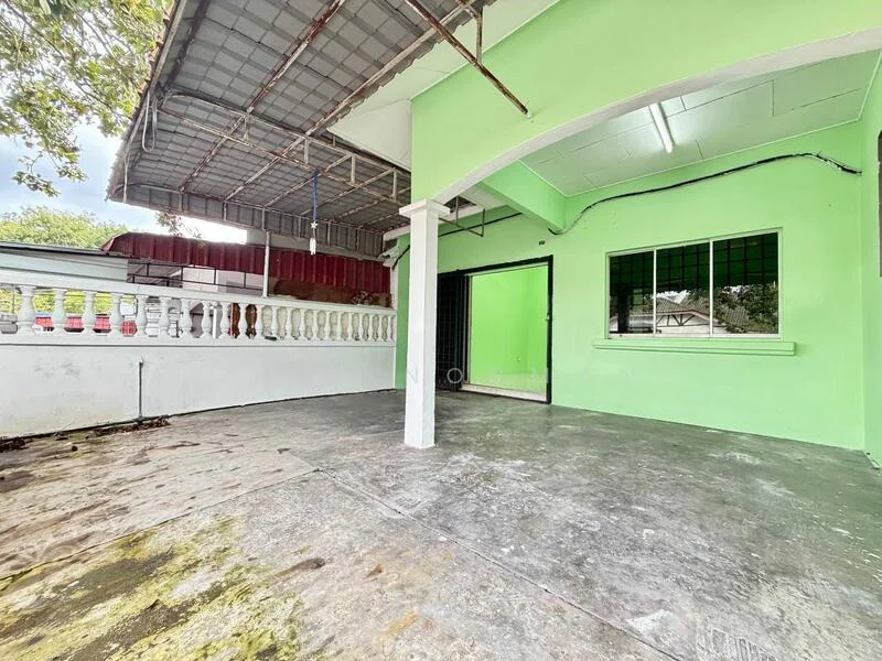 Exterior features: green painted walls, concrete flooring, covered roof, window with black grille, white railing, open space, exposed beams; style: modern.