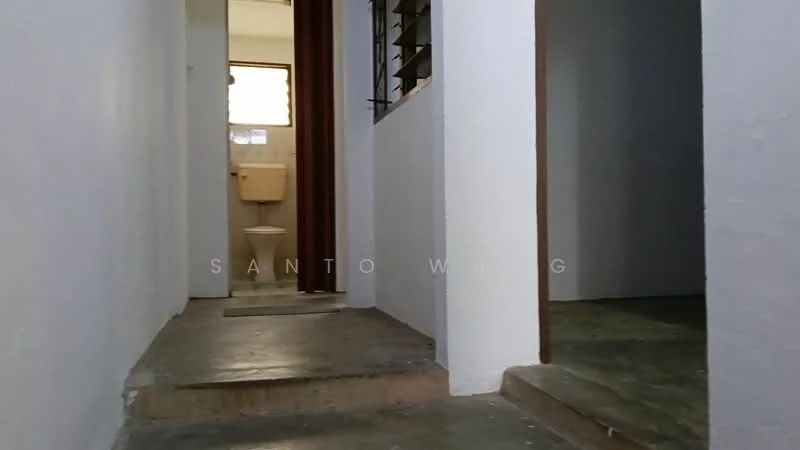 Room features: white painted walls, concrete flooring, doorway leading to bathroom, window with horizontal slats, light source from ceiling, neutral color scheme.