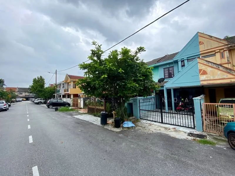 Exterior type: linked terrace house; features: blue painted facade, gated entrance, manicured lawn, mature trees, single-storey, driveway with interlocking pavers, surrounded by residential buildings, street view with parked cars; style: modern.
