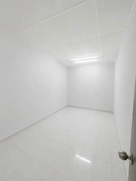 Room features: white painted walls, white ceiling, fluorescent lighting, glossy ceramic tile flooring, single door, no visible furniture or decor; style: minimalist.