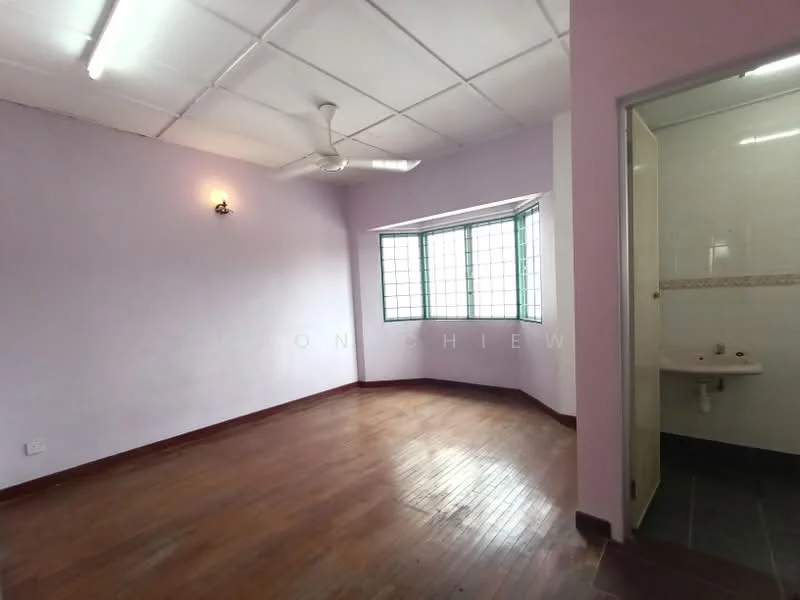 Room features: purple painted walls, wooden flooring, ceiling fan, large windows with green frames, sink with faucet, tile flooring in bathroom area, wall-mounted light fixture.
