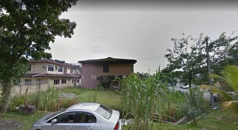 Exterior type: detached bungalow; features: overgrown grass, surrounding trees, single-storey structure, car parked in front, adjacent residential buildings, unmaintained landscaping; style: traditional.