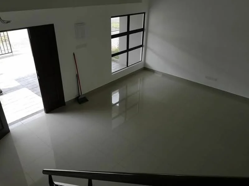Room features: white painted walls, glossy ceramic tile flooring, large windows with black frames, main entrance door, sweeping broom, natural light from windows; style: modern; view: garden.