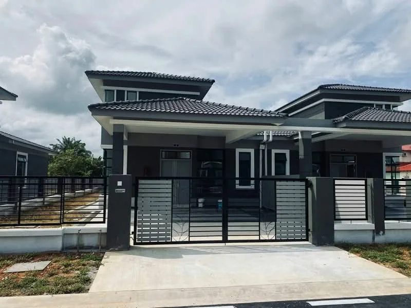 Exterior type: semi-detached house; features: grey painted facade, pitched tile roof, black metal gate, concrete driveway, manicured lawn, surrounded by greenery, single-storey, front porch, large windows; style: modern.
