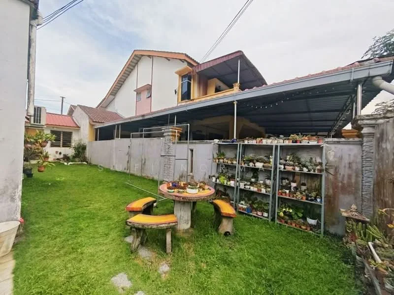 Exterior type: detached bungalow; features: manicured lawn, garden area with potted plants, outdoor seating area with circular table, concrete wall surrounding the property, covered carport, roof overhang, multiple roof styles, decorative garden elements; style: modern.
